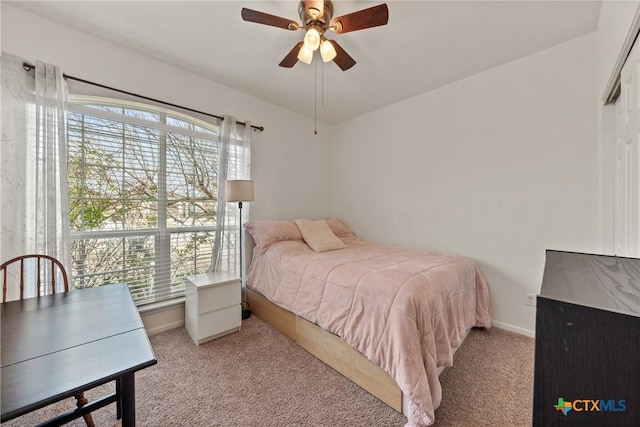 carpeted bedroom featuring multiple windows