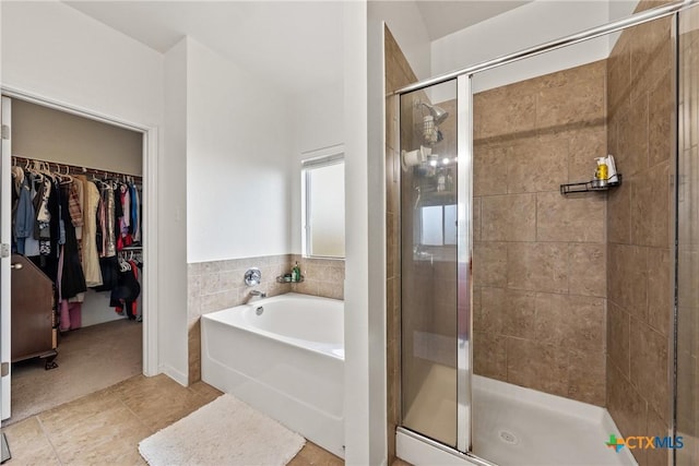 bathroom featuring tile patterned floors and shower with separate bathtub