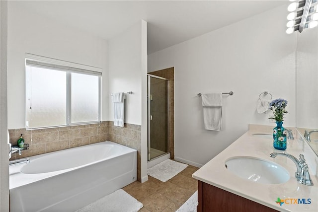 bathroom with tile patterned flooring, vanity, and shower with separate bathtub