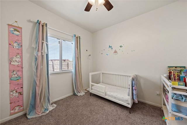 carpeted bedroom with a nursery area and ceiling fan