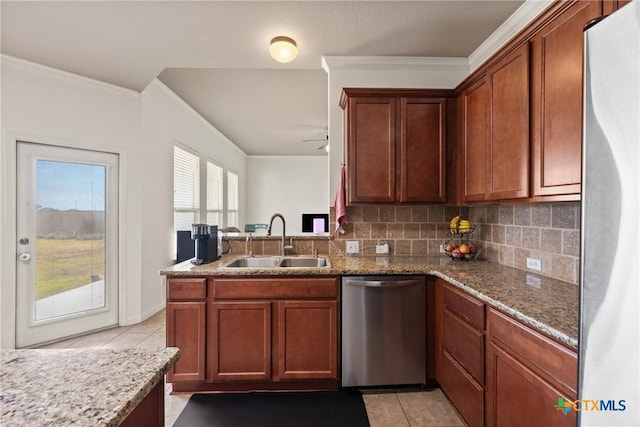 kitchen featuring sink, appliances with stainless steel finishes, light stone counters, light tile patterned flooring, and decorative backsplash