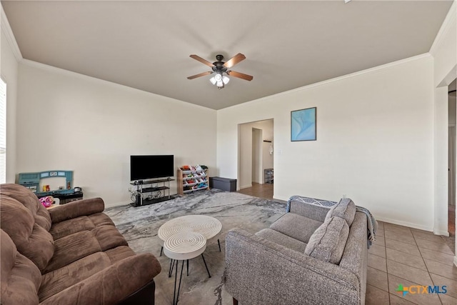 living room with tile patterned flooring, crown molding, and ceiling fan