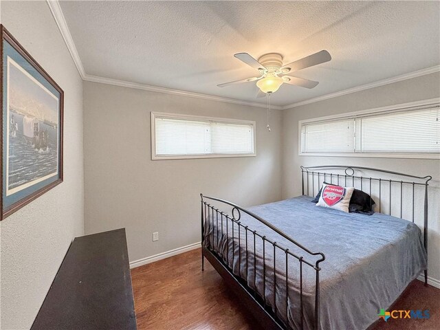 209 Lake Frst, Canyon Lake, TX 78133 - bedroom with wood finished floors, crown molding, baseboards, a textured ceiling, and ceiling fan