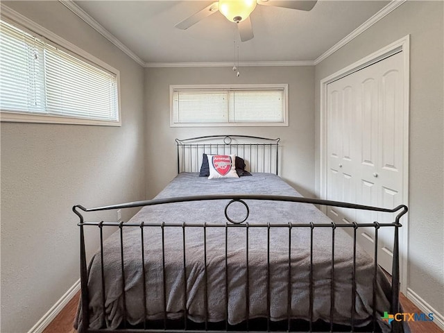 209 Lake Frst, Canyon Lake, TX 78133 - bedroom featuring a ceiling fan, baseboards, a closet, and ornamental molding