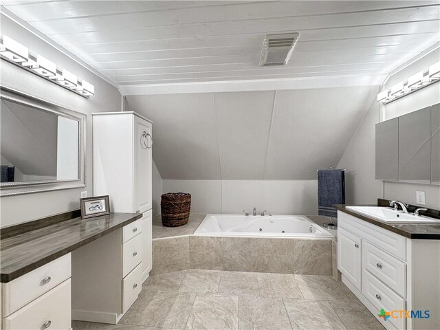 209 Lake Frst, Canyon Lake, TX 78133 - full bath featuring lofted ceiling, visible vents, vanity, and a tub with jets