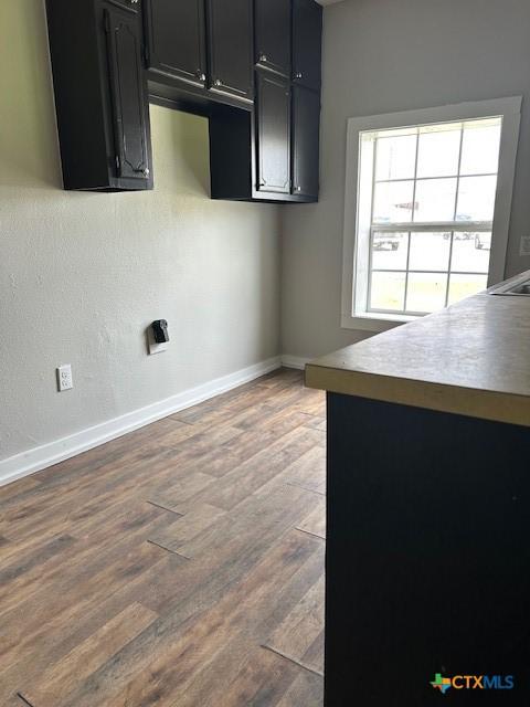 101 S Vine St, Victoria, TX 77901 - kitchen with dark cabinetry and wood finished floors