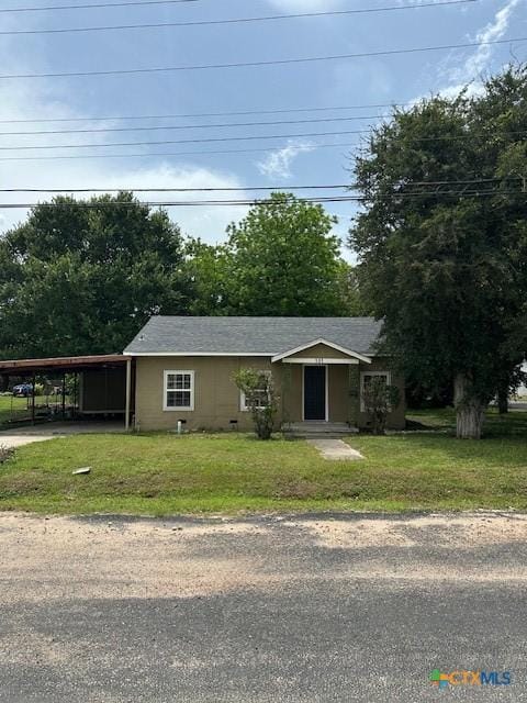 101 S Vine St, Victoria, TX 77901 - view of front facade with an attached carport, a front yard, and driveway