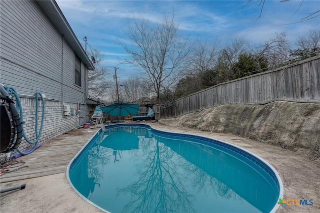 view of pool with a wooden deck