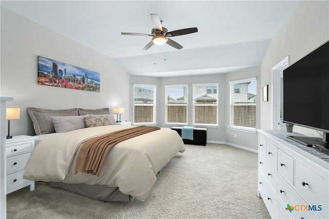 bedroom featuring vaulted ceiling, light colored carpet, baseboards, and ceiling fan