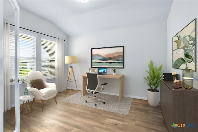 home office featuring vaulted ceiling, wood finished floors, and baseboards