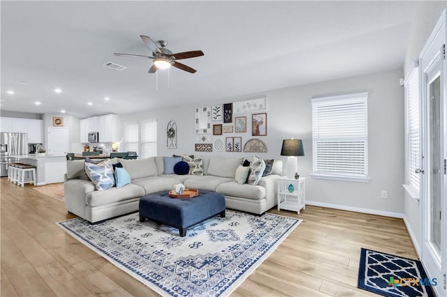 living area featuring visible vents, baseboards, recessed lighting, light wood-style floors, and a ceiling fan