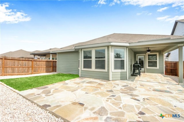 rear view of property with a patio, a fenced backyard, and ceiling fan