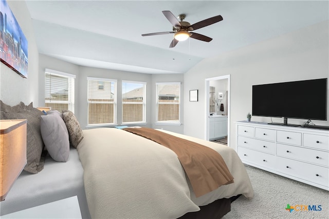 bedroom with lofted ceiling, light colored carpet, ceiling fan, and ensuite bathroom