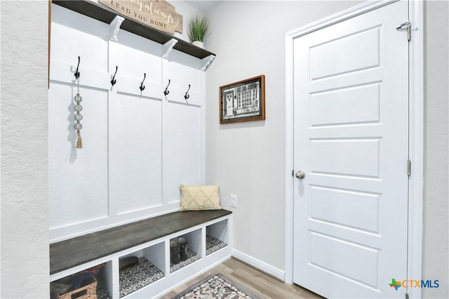 mudroom with baseboards and wood finished floors