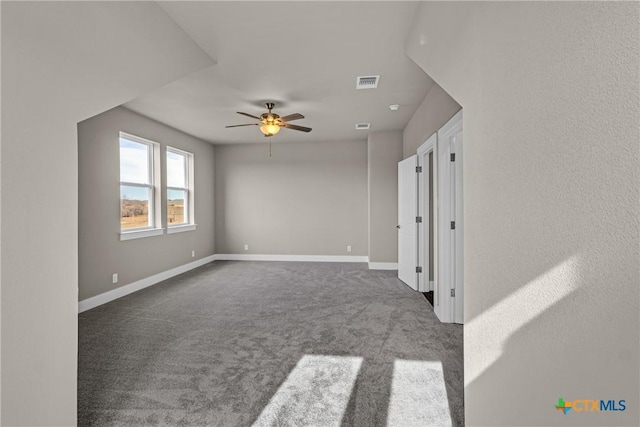 unfurnished room with ceiling fan and carpet