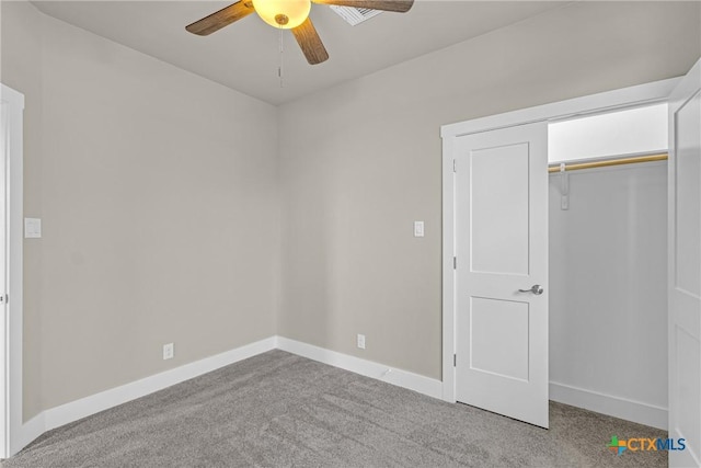 unfurnished bedroom with ceiling fan, a closet, and light carpet