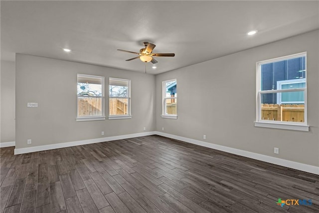 unfurnished room with ceiling fan and dark wood-type flooring