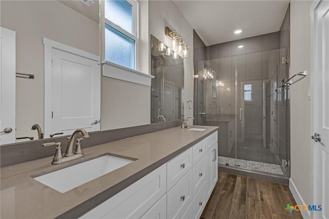 bathroom with a shower with door, vanity, and hardwood / wood-style floors