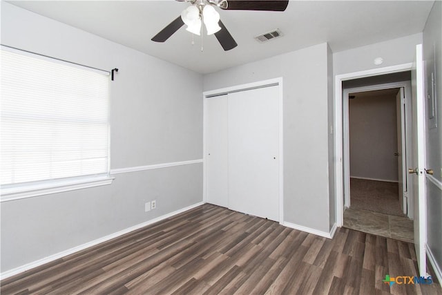 2709 San Jacinto Rd, Temple, TX 76502 - unfurnished bedroom with wood finished floors, a closet, multiple windows, and baseboards