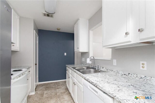 2709 San Jacinto Rd, Temple, TX 76502 - kitchen featuring white appliances, a sink, white cabinets, and baseboards