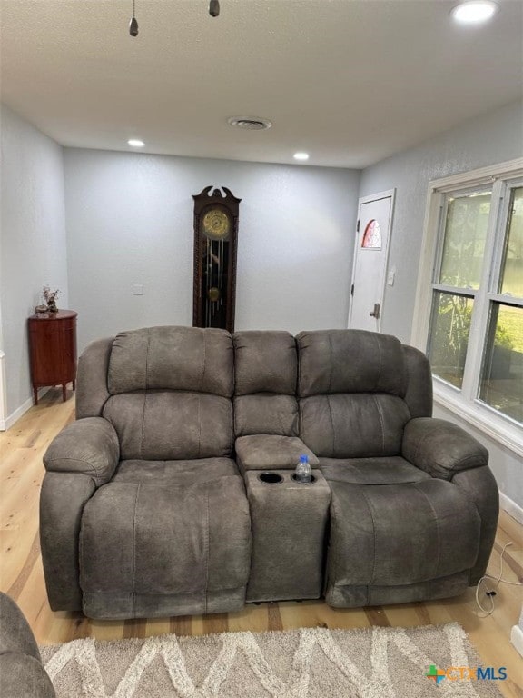 living room featuring recessed lighting, wood finished floors, and baseboards