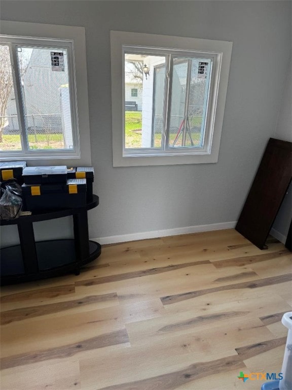 interior space with wood finished floors and baseboards