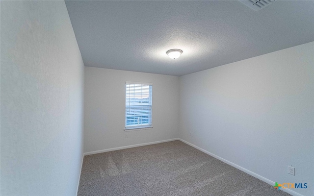 carpeted spare room with a textured ceiling