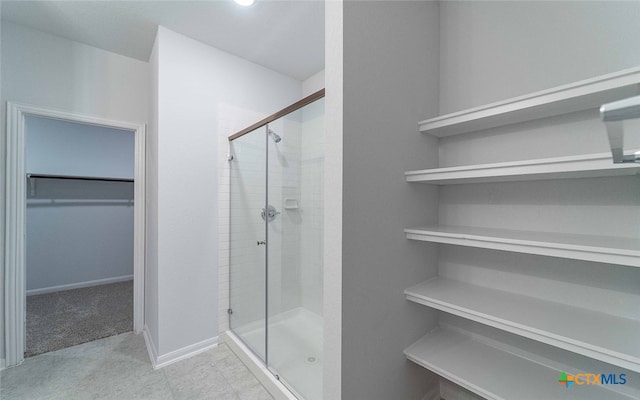 bathroom featuring a shower with door