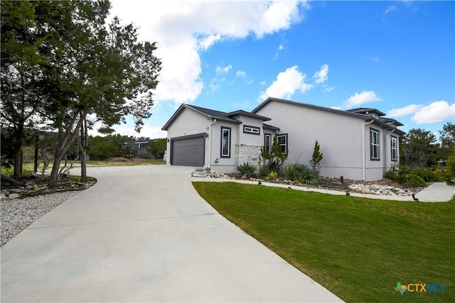 view of front of home with a garage and a front lawn