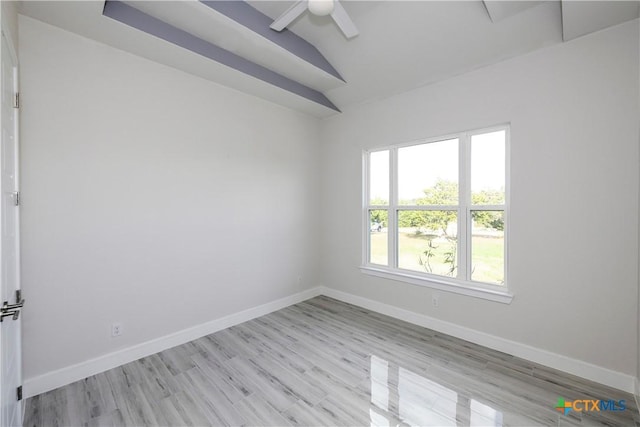 empty room featuring vaulted ceiling, light hardwood / wood-style flooring, and ceiling fan