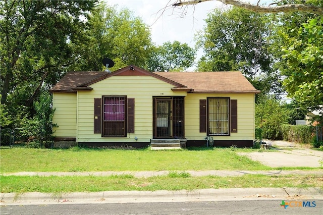 bungalow-style home featuring a front yard