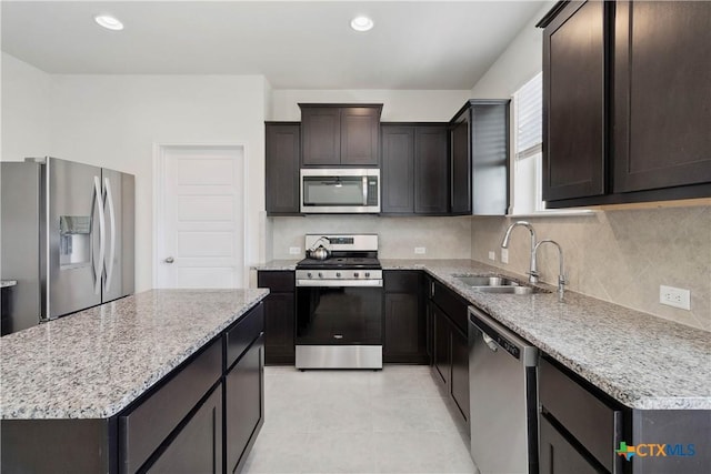 109 Cypress Hills Rd, San Marcos, TX 78666 - kitchen with stainless steel appliances, tasteful backsplash, dark brown cabinetry, light tile patterned flooring, and light stone counters