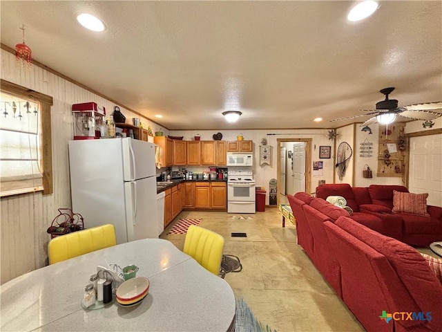 604 N 14th St, Port Oconnor, TX 77982 - kitchen featuring white appliances, open floor plan, ceiling fan, recessed lighting, and dark countertops