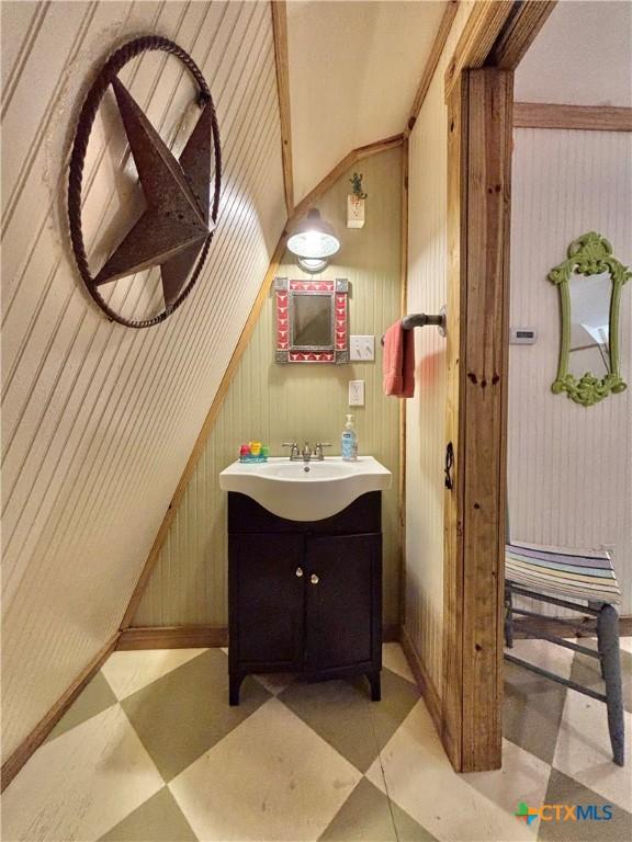 604 N 14th St, Port Oconnor, TX 77982 - bathroom featuring vanity, tile patterned floors, wood walls, and vaulted ceiling