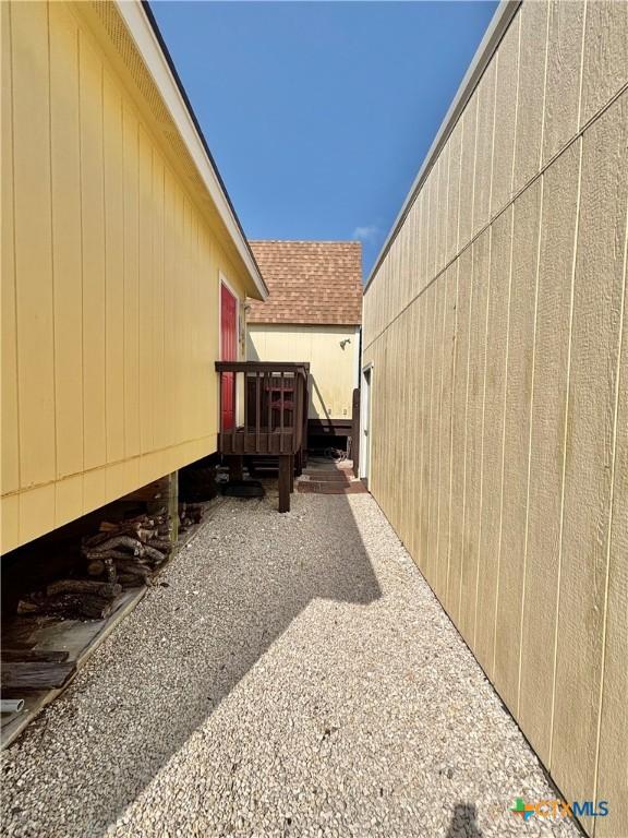 604 N 14th St, Port Oconnor, TX 77982 - view of side of property with a deck and roof with shingles