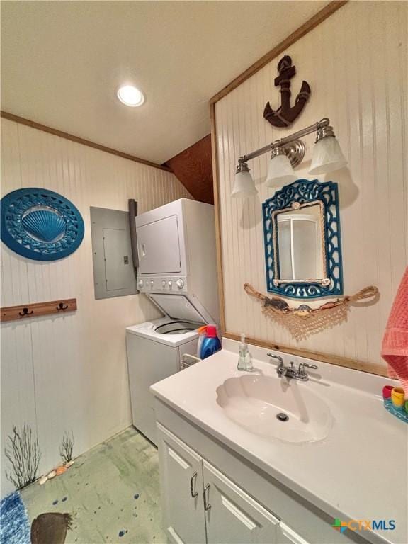 604 N 14th St, Port Oconnor, TX 77982 - bathroom with stacked washing machine and dryer, electric panel, vanity, and recessed lighting