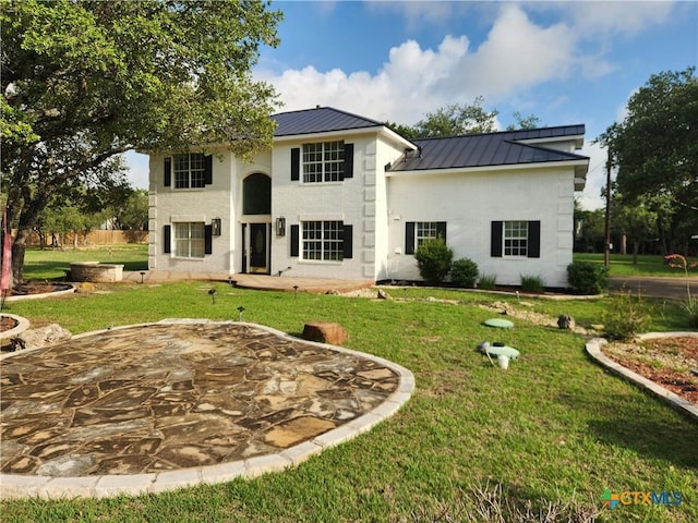102 County Road 180, Leander, TX 78641 - rear view of house featuring a standing seam roof, a lawn, and a metal roof