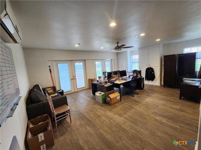 102 County Road 180, Leander, TX 78641 - living room featuring a wall unit AC, french doors, a desk, wood finished floors, and recessed lighting