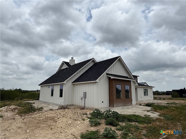 6340 Water Supply Rd, Temple, TX 76502 - rear view of property with a shingled roof and board and batten siding