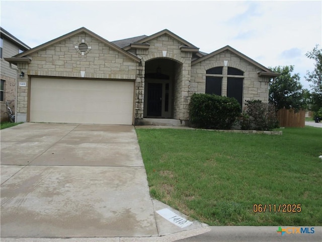 1418 Fawn Lily Dr, Temple, TX 76502 - french country home featuring a front lawn, an attached garage, driveway, and stone siding