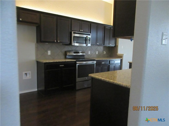 1418 Fawn Lily Dr, Temple, TX 76502 - kitchen with stainless steel appliances, decorative backsplash, dark wood-style floors, dark brown cabinetry, and a textured wall