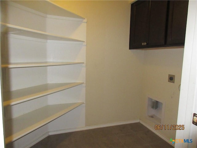1418 Fawn Lily Dr, Temple, TX 76502 - laundry area featuring cabinet space, electric dryer hookup, and dark tile patterned flooring
