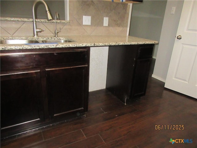 1418 Fawn Lily Dr, Temple, TX 76502 - kitchen featuring tasteful backsplash, light stone countertops, and dark wood-style flooring