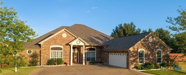 1004 Shady Hollow Ct, Nolanville, TX 76559 - view of front of property with concrete driveway, an attached garage, and brick siding