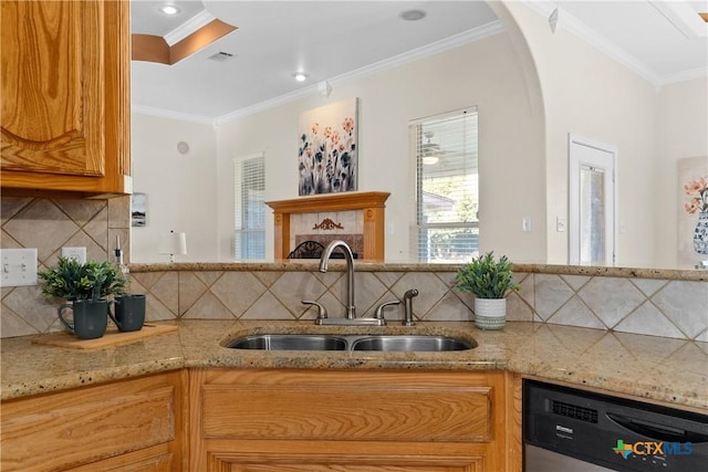 kitchen featuring arched walkways, dishwasher, light stone countertops, crown molding, and a sink