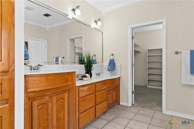 bathroom featuring double vanity, visible vents, and ornamental molding