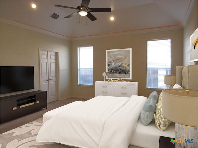 carpeted bedroom featuring lofted ceiling, recessed lighting, visible vents, ornamental molding, and baseboards