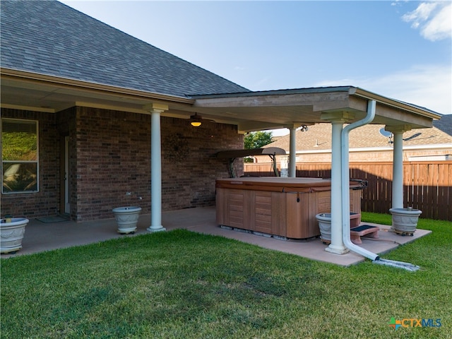 view of yard with a patio area, a hot tub, and fence