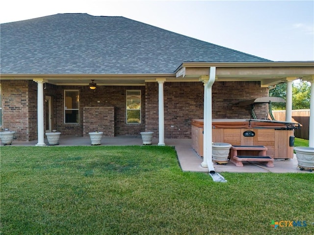 1004 Shady Hollow Ct, Nolanville, TX 76559 - rear view of property with a hot tub, a patio area, a shingled roof, and brick siding