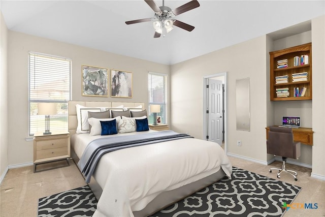 bedroom featuring light carpet, ceiling fan, and baseboards